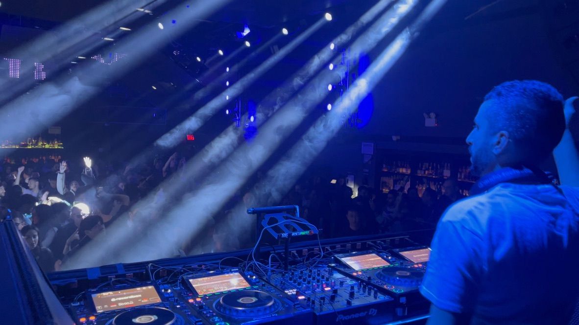 Light beams over a packed club